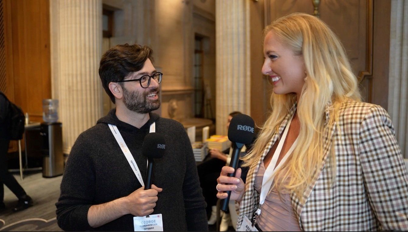 Adleigh interviewing an attendee in glasses
