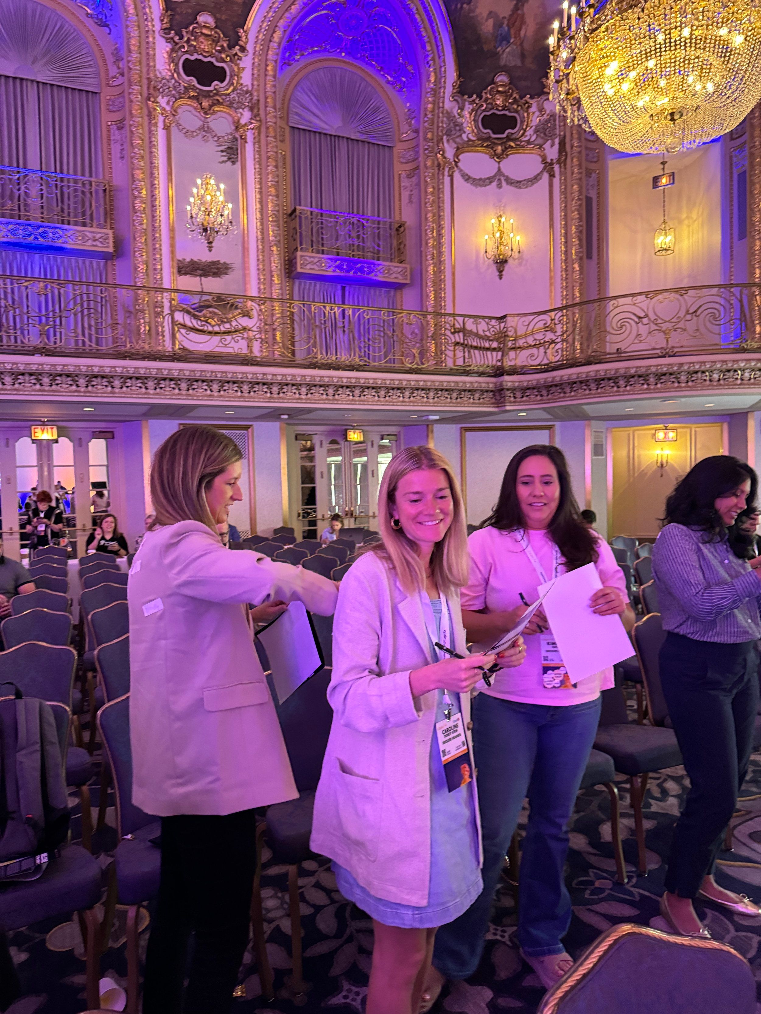 Event crew reviewing notes in an ornate ballroom