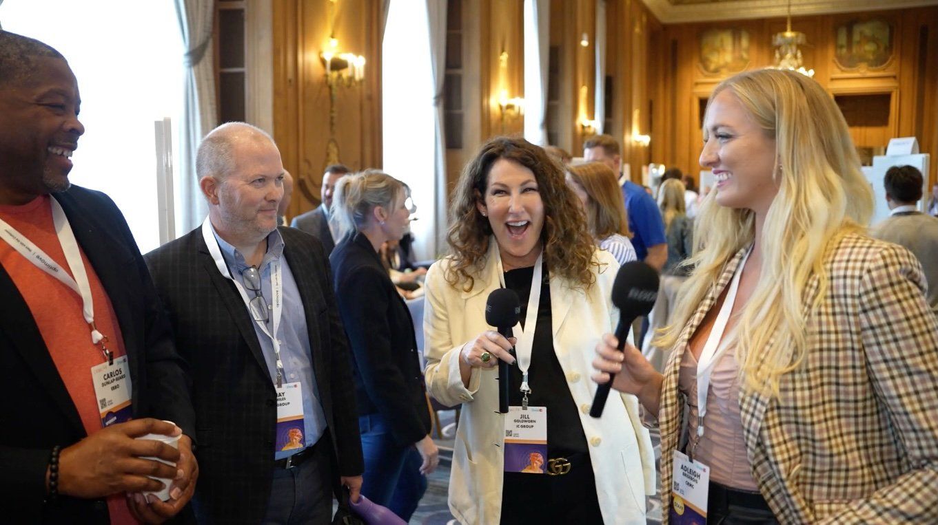 Adleigh interviewing a group of smiling conference attendees